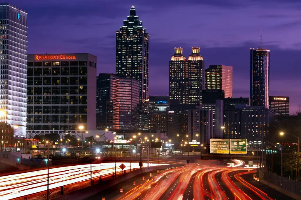 Atlanta skyline at dusk, lit towers above the downtown connector